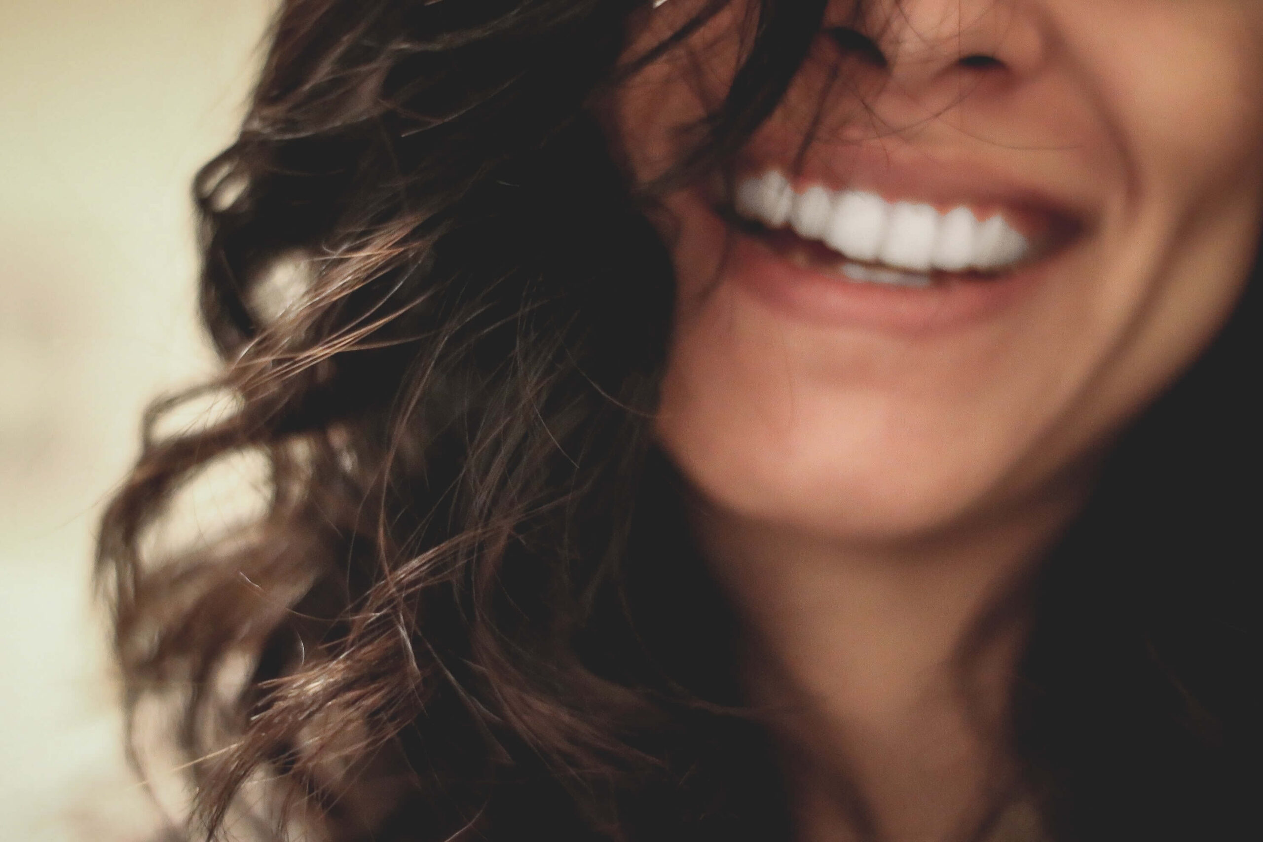 a woman with dark brown hair and a big wide smile