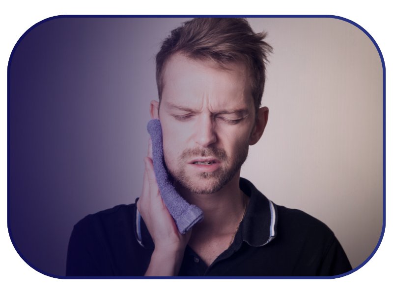 Man with severe toothache holding a cold compress to his face, showing need for emergency dental care in London.