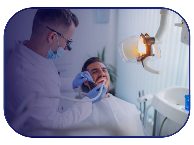 Dentist examining a patient’s teeth during a routine dental check-up in a modern clinic.
